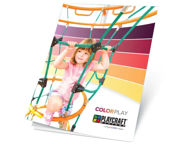 Smiling girl on a colorful rope climbing structure with gradient background.