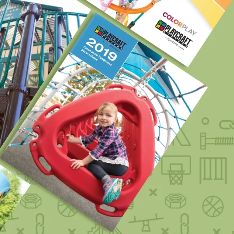Young girl sitting inside a red triangular climbing structure on a playground.