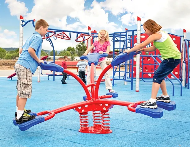 Three children balancing on a red and blue spring-based seesaw in a playground.