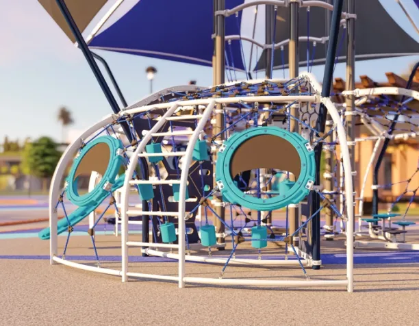 Climbing dome with circular windows and ropes under a blue shade canopy.