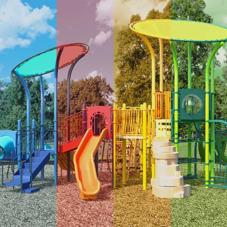 Playground with divided color scheme: blue, red, yellow, and green sections featuring slides and climbing structures.